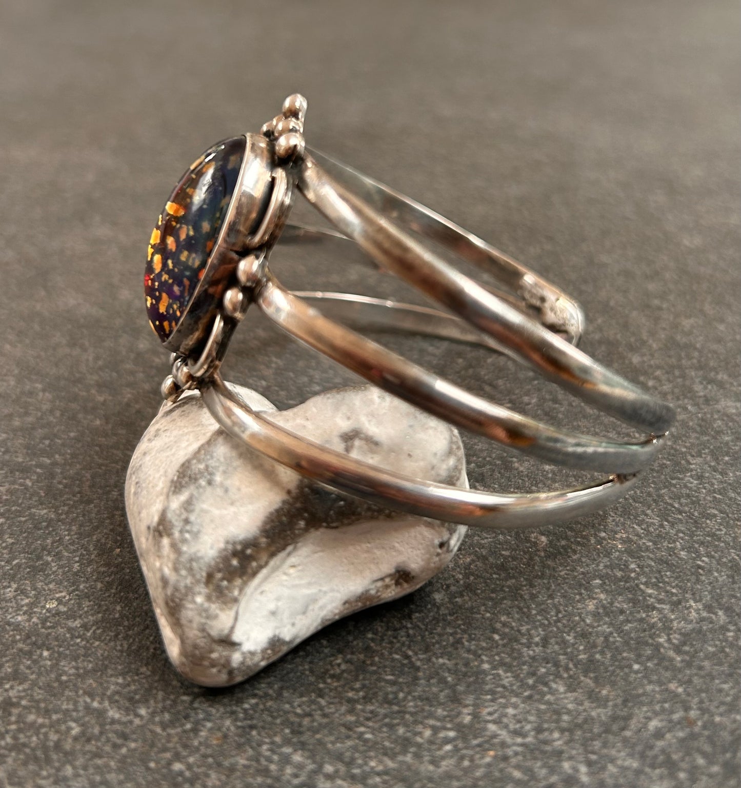 A striking vintage sterling silver bangle featuring a beautiful domed glass cabochon