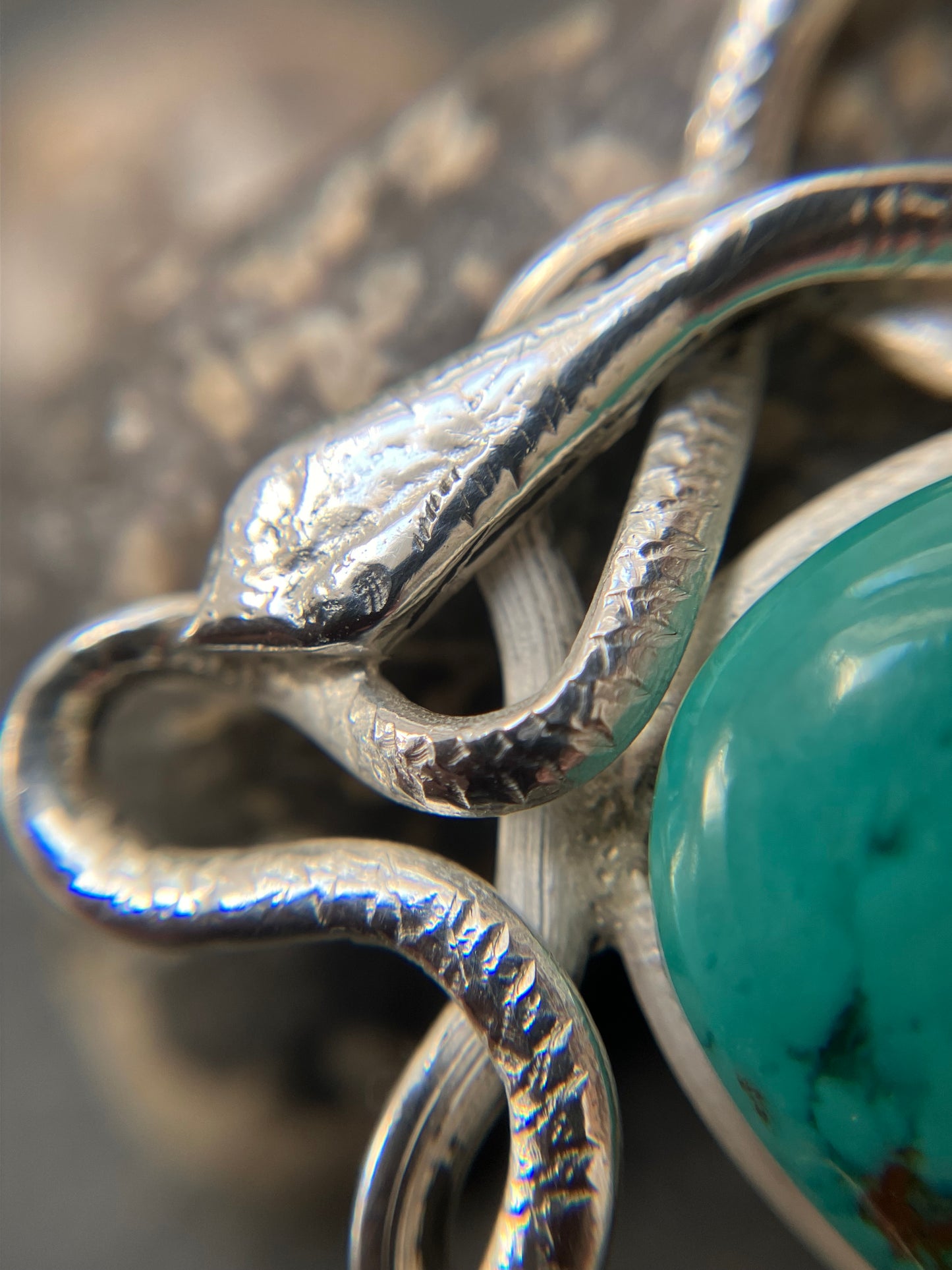 Artisan vintage sterling silver intertwining snake pendant with a piece of Turqurenite in the centre.