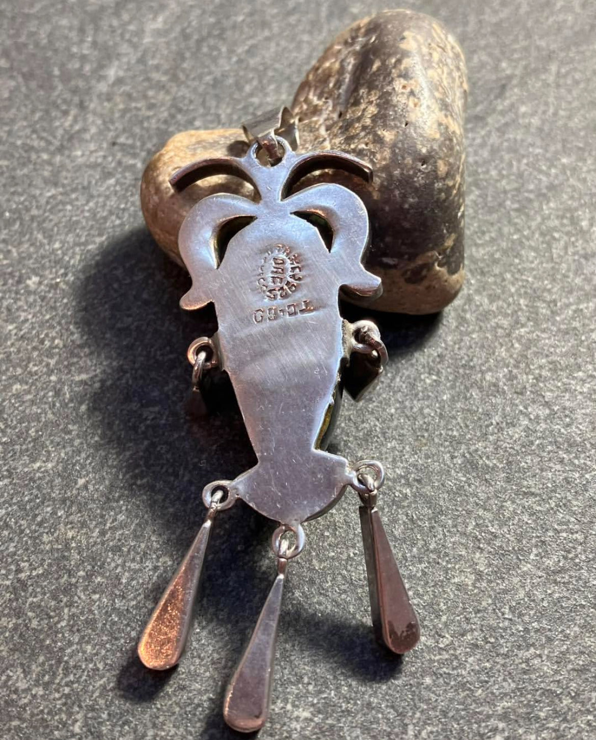 A striking vintage Mexican warrior face pendant crafted in sterling silver.