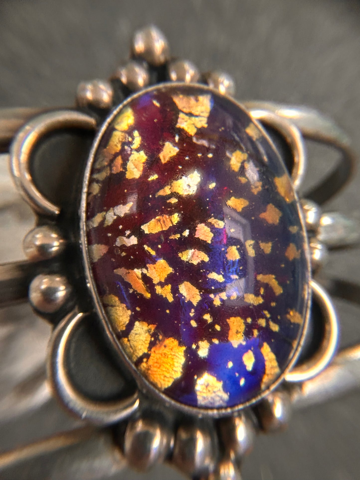A striking vintage sterling silver bangle featuring a beautiful domed glass cabochon