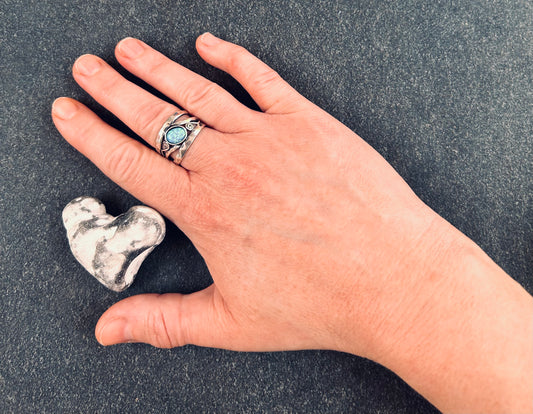 Vintage sterling silver artisan ring featuring a captivating lab-created opal