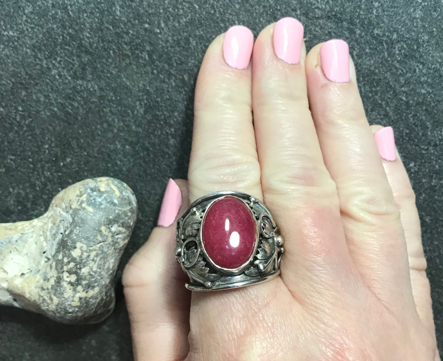 Spectacular statement vintage sterling silver Ruby cabochon with beautiful 3D floral detail at each side.