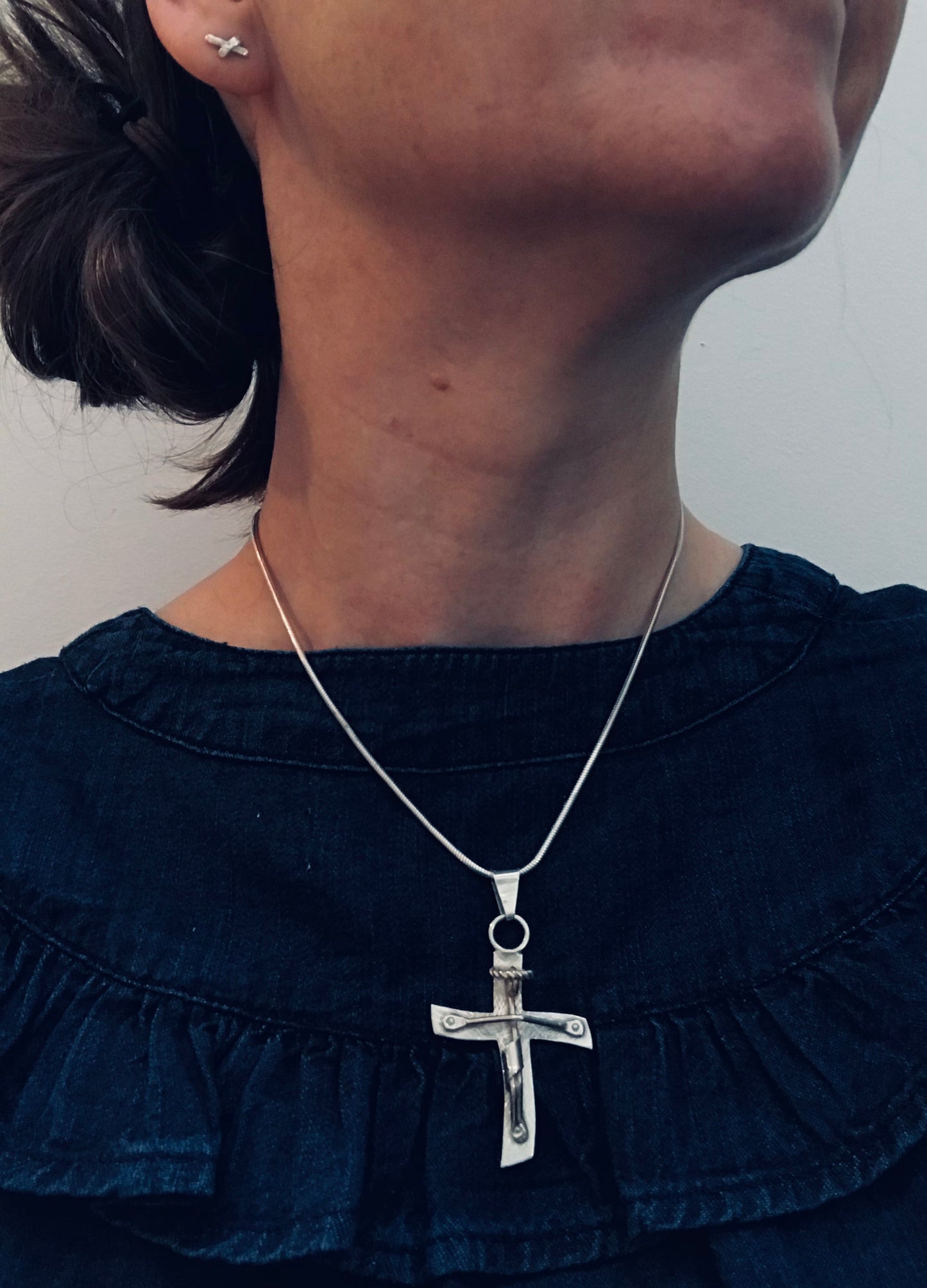 Brutalist modernist sterling silver vintage Mexican cross with a naive representation of Jesus.