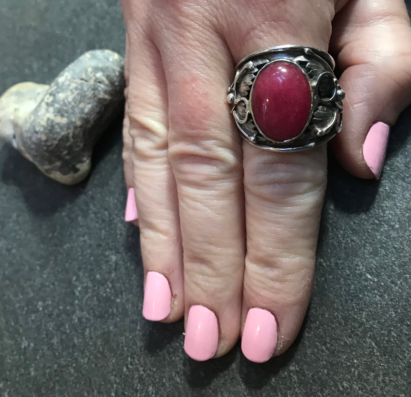 Spectacular statement vintage sterling silver Ruby cabochon with beautiful 3D floral detail at each side.