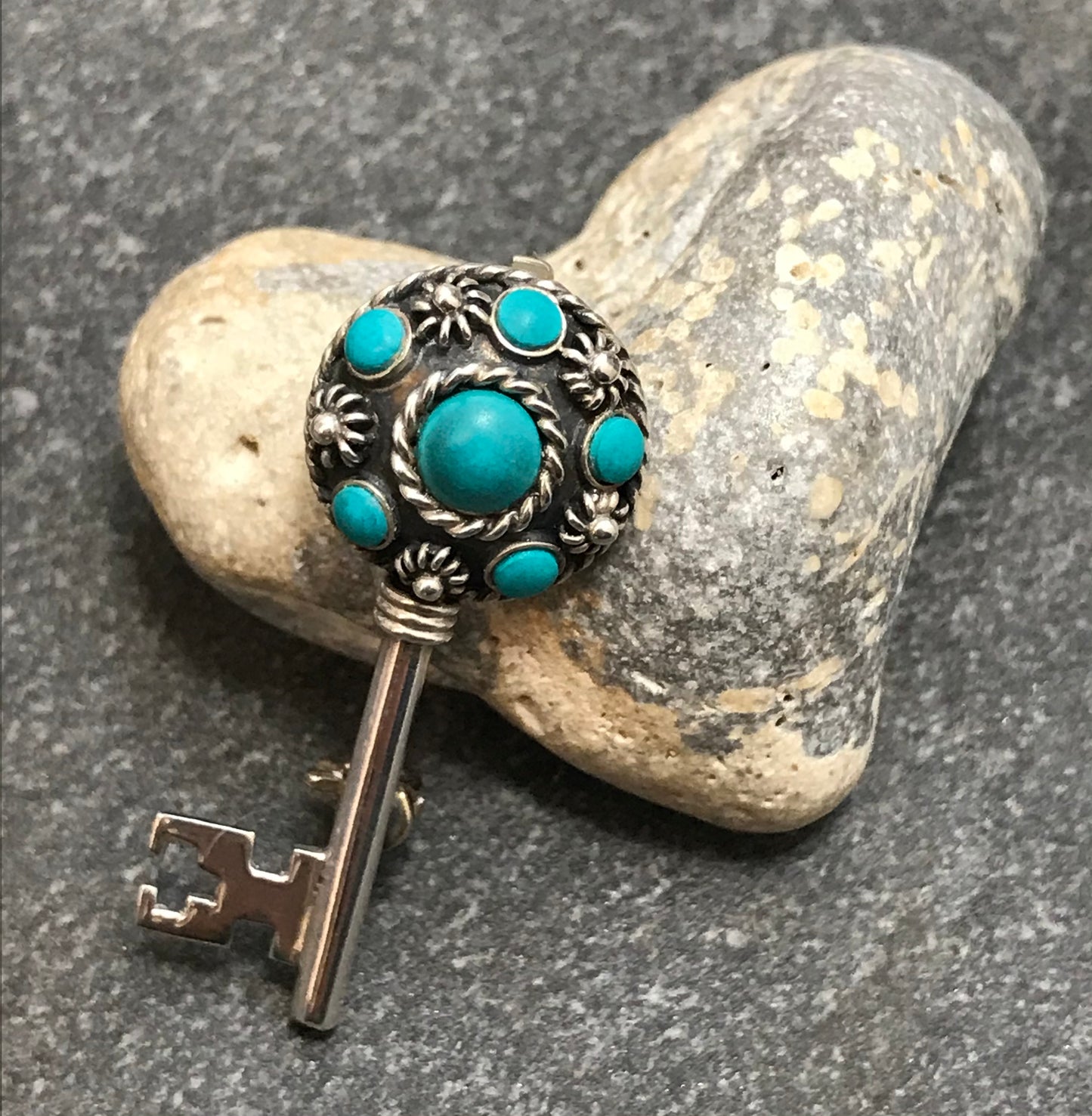 Vintage sterling silver key brooch with lovely turquoise cabochons.