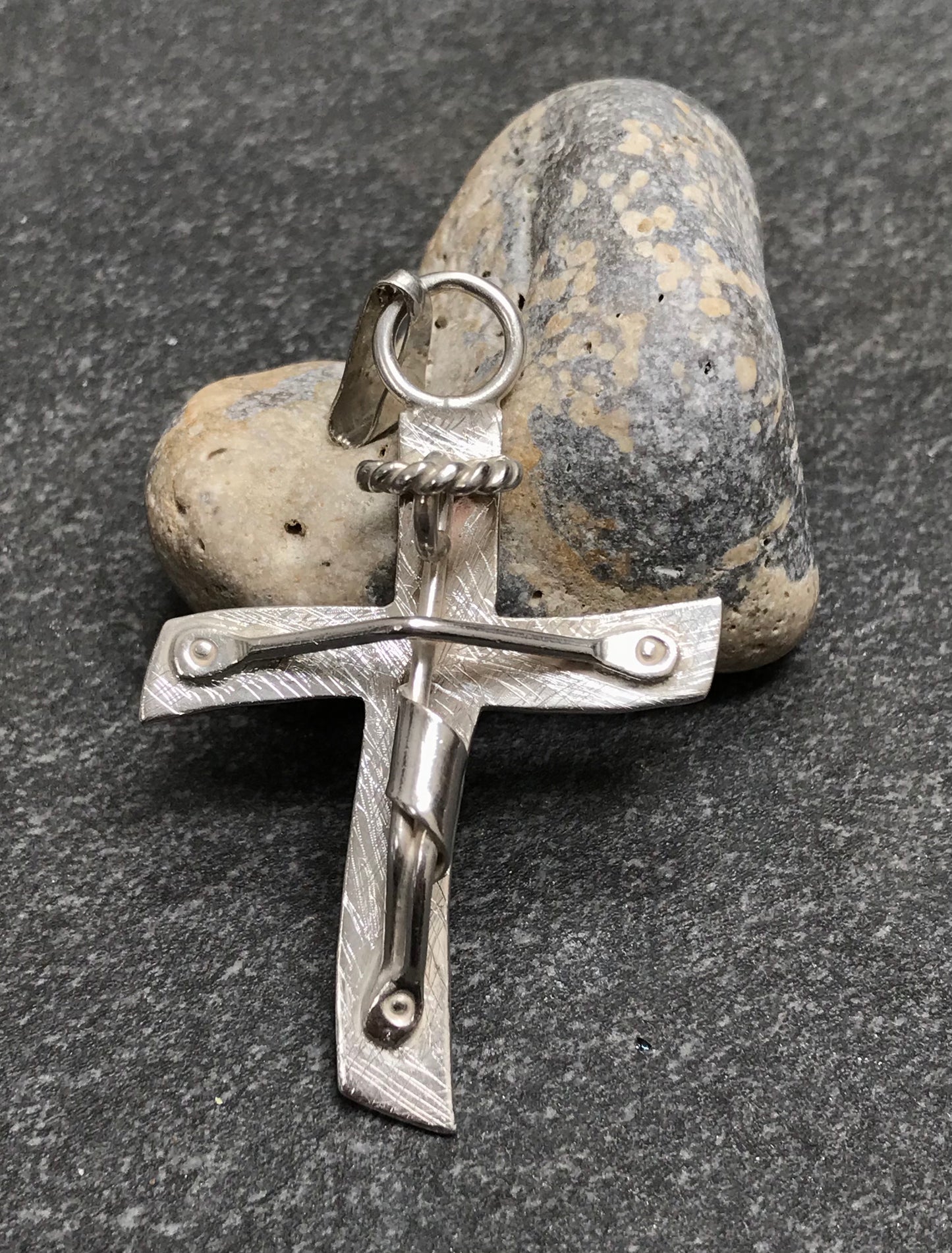 Brutalist modernist sterling silver vintage Mexican cross with a naive representation of Jesus.