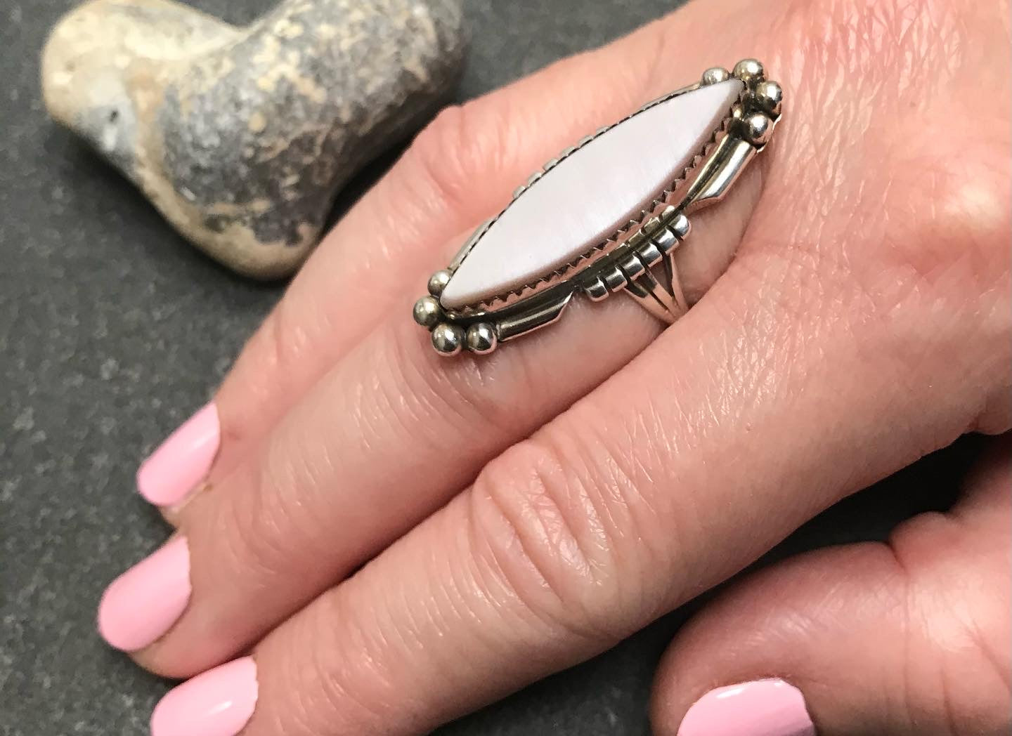 Vintage Native American sterling silver ring with mother of pearl set in a zig zag bezel setting.