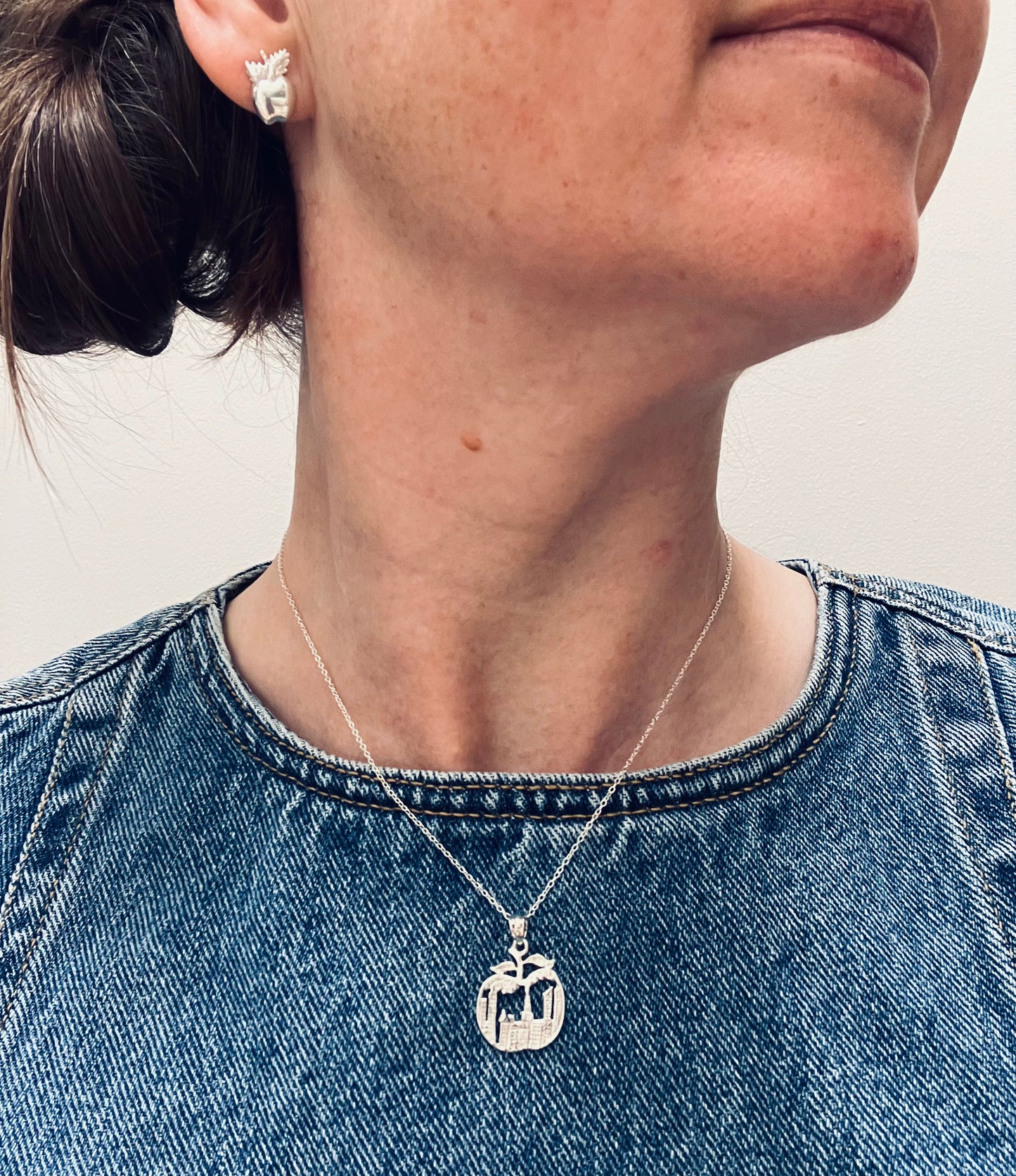 Apple pendant depicting the scene of New York sky line inside an apple.