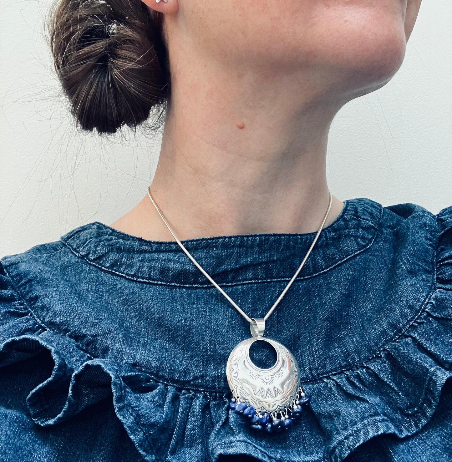 Vintage sterling silver circular pendant with lovely design embossed into the silver